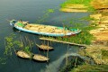 শীতলক্ষ্যা নদীর পাড়ে দির্ঘদিন যাবৎ গড়ে উঠেছে অবৈধ বিশাল পাইকারী বাঁশের আড়ৎ। ছবিটি ডেমরার ওপারে রুপগঞ্জ এলাকা থেকে তোলা।